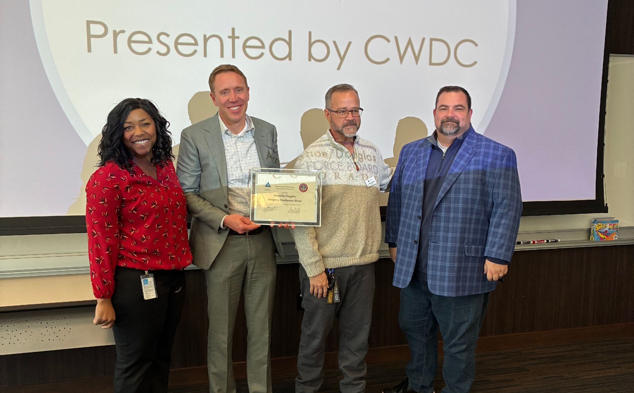 A/D Works! board members pose for photo with board award.