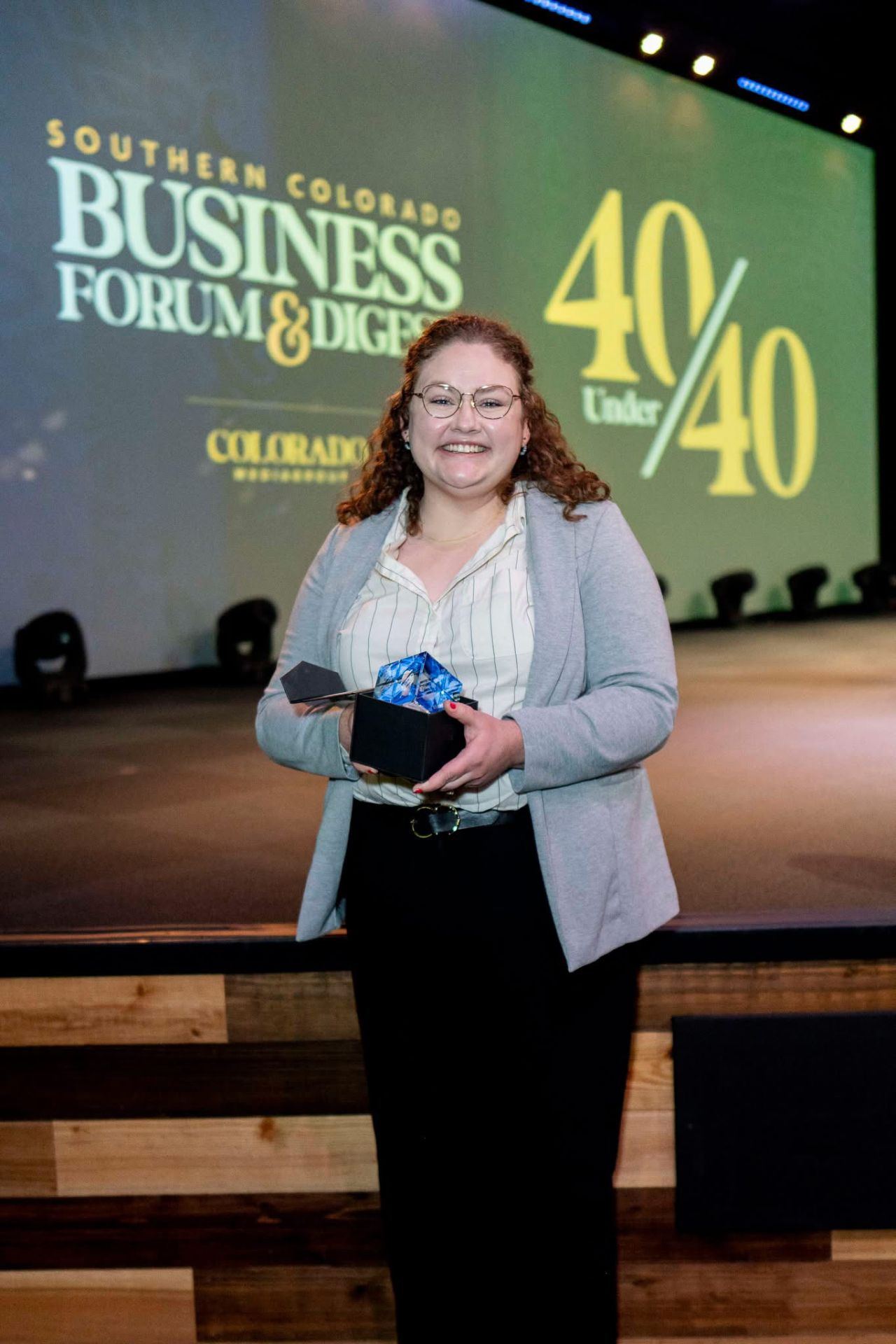 Sami Mooney holds Souther Colorado 40 under 40 award in her hands