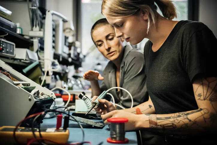 two women working on electronics