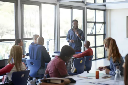 man of color teaching group of students