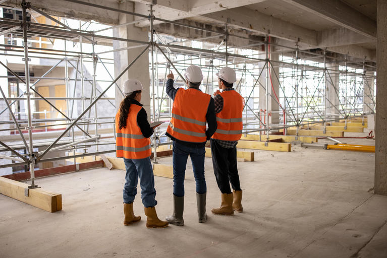 Three construction students at a job site
