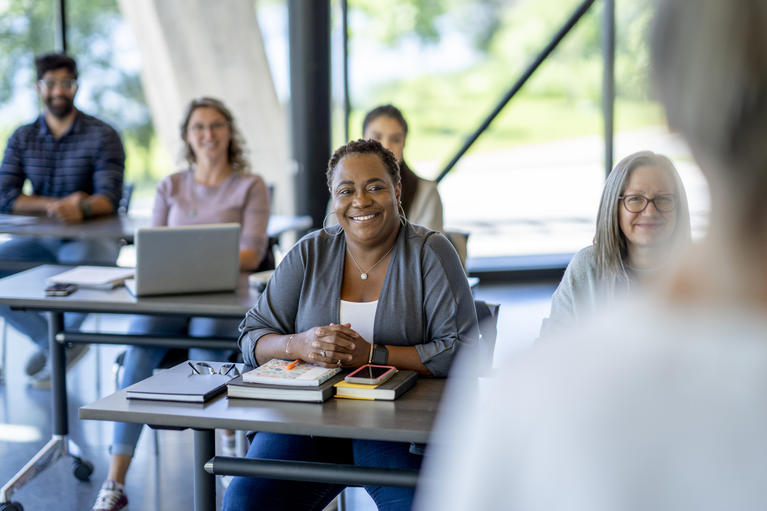 Group of youth and adult learners in a classroom