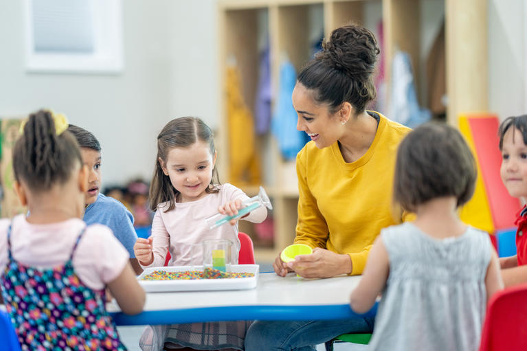 Early Education professional teaching in classroom with young children 