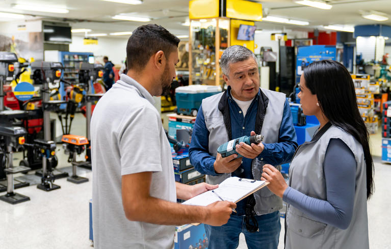 Photo of Business Manager Training Apprentices in store.