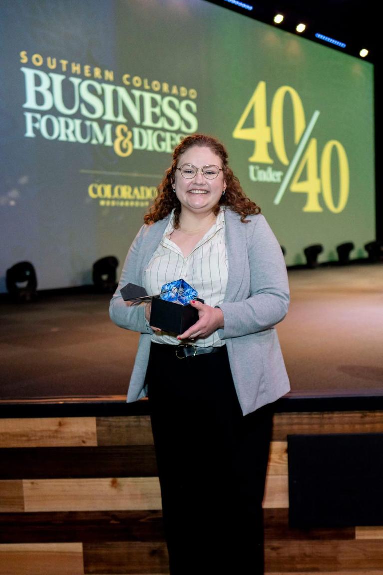 Sami Mooney holds 40 Under 40 Award