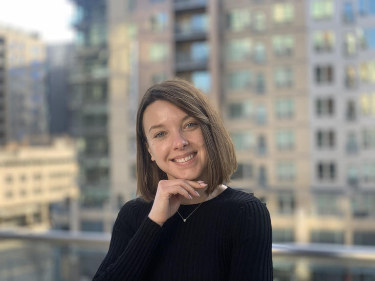 Professional photo of Vera K standing in front of cityscape background